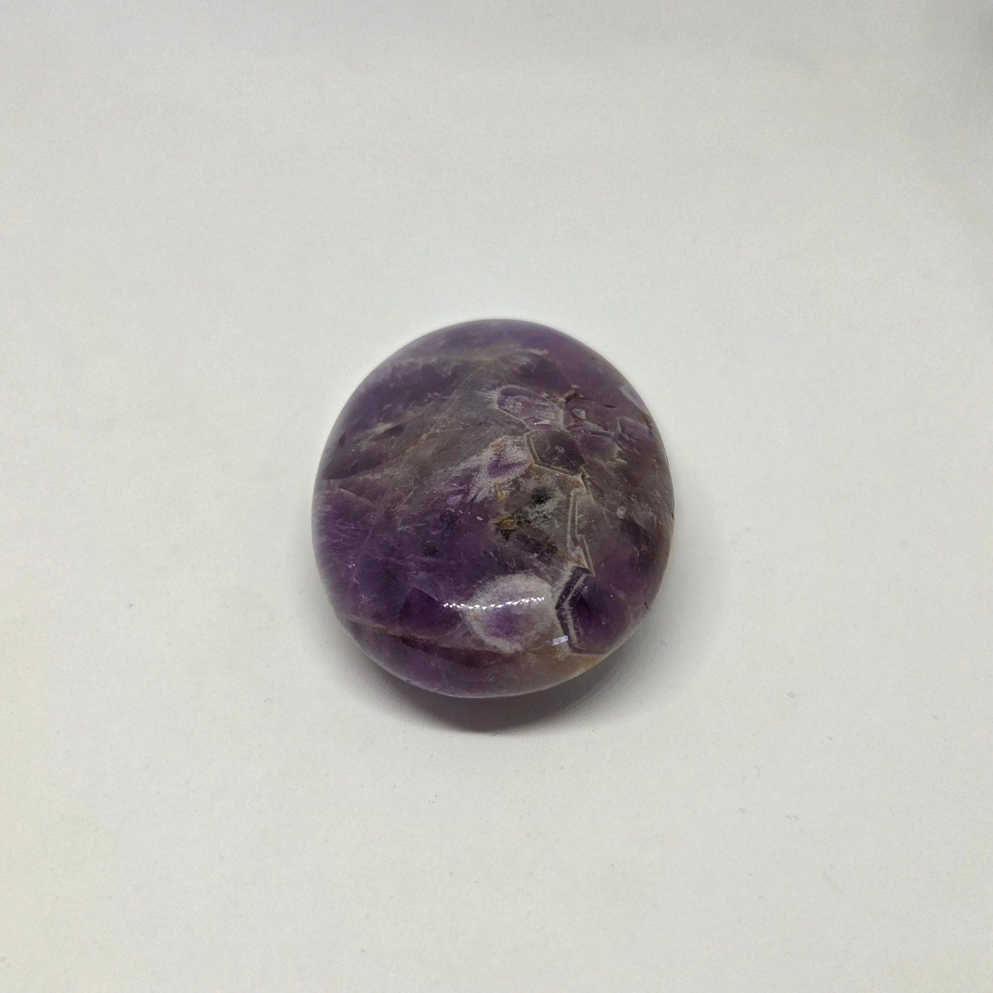 Round purple stone on a white background