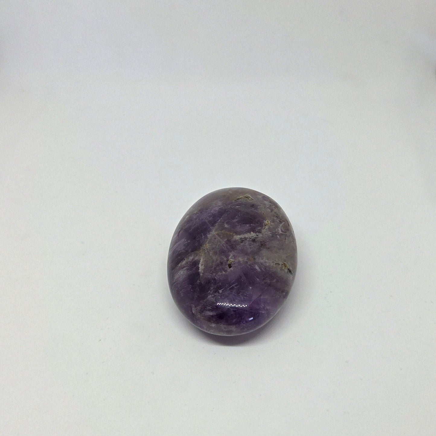 Purple amethyst stone on a white background