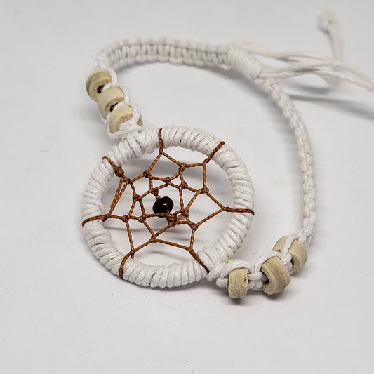 A white dream catcher bracelet with a beige cord and a central circular web design, featuring a bead for the 'dream' and small beads as embellishments.