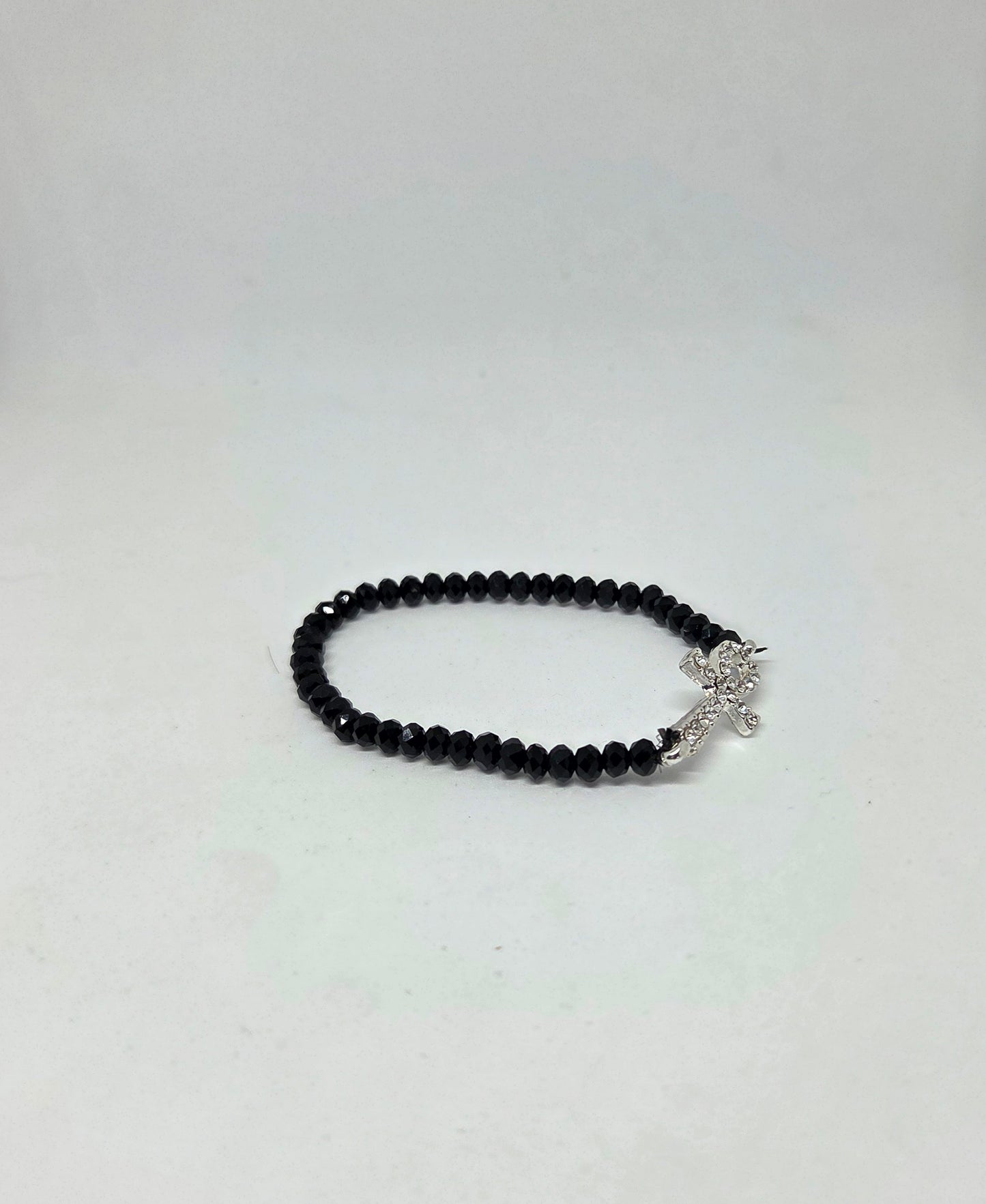 Black beaded bracelet with a silver clasp on a white background