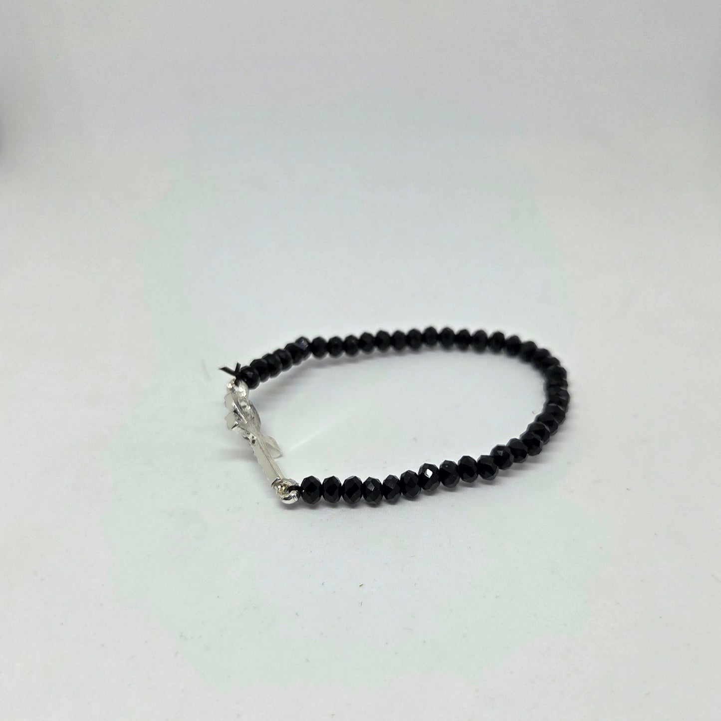 Black beaded bracelet on a white background