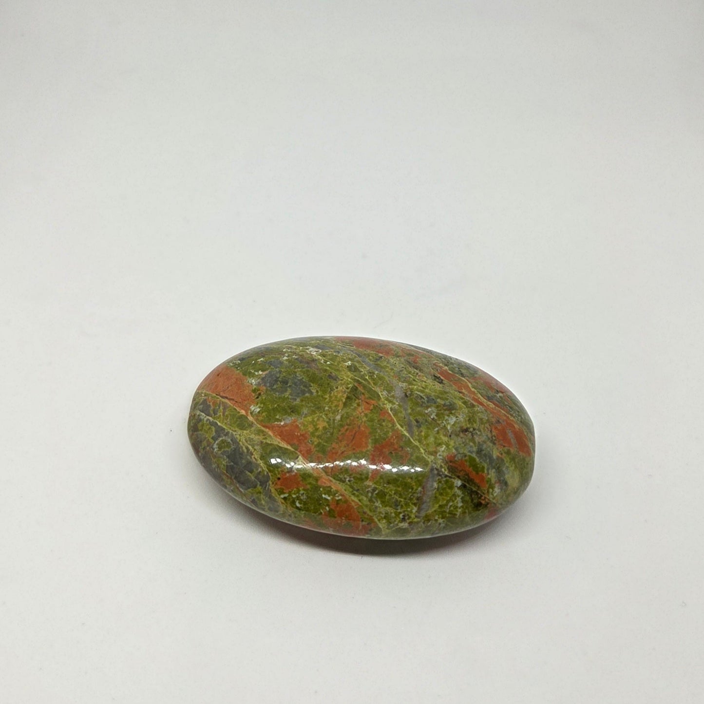 Polished multicolored stone on a white background
