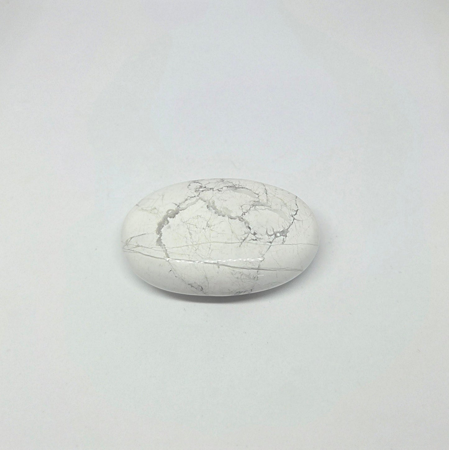 Round white stone with a cracked texture on a light gray background