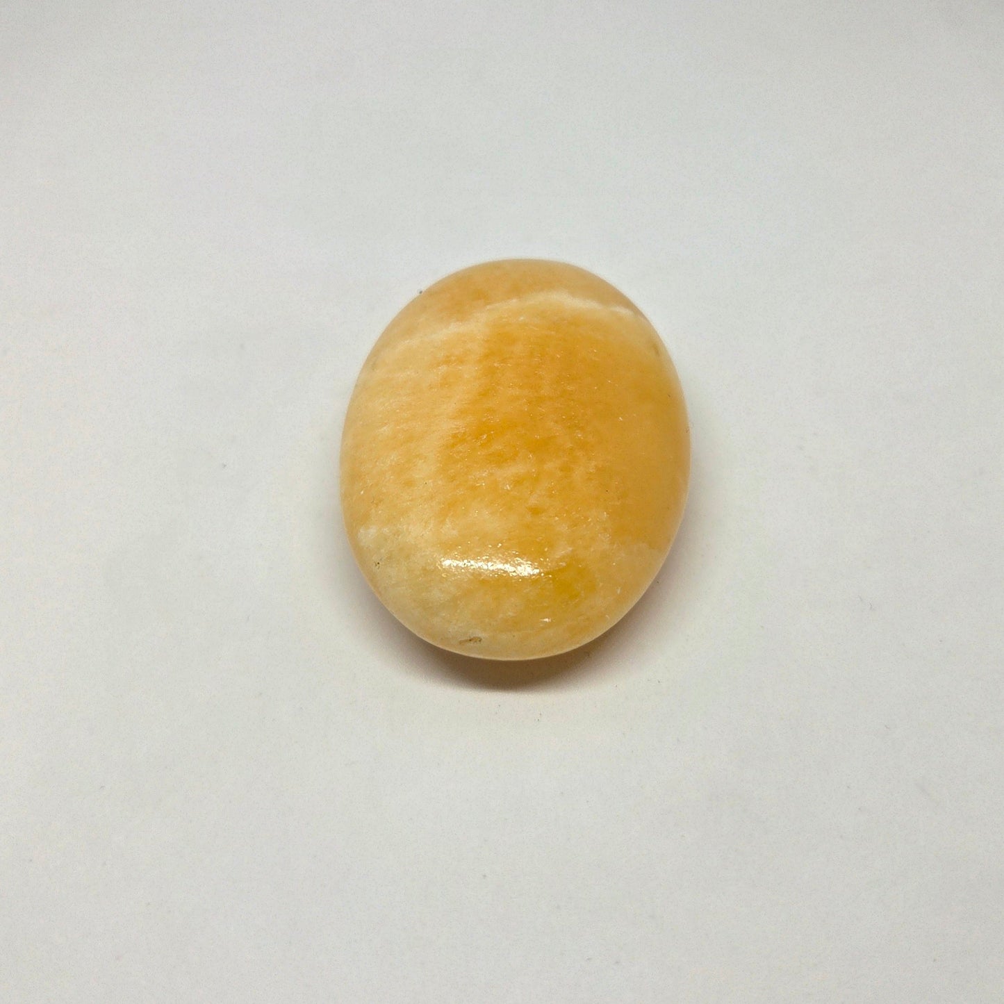 Round yellow stone on a white background