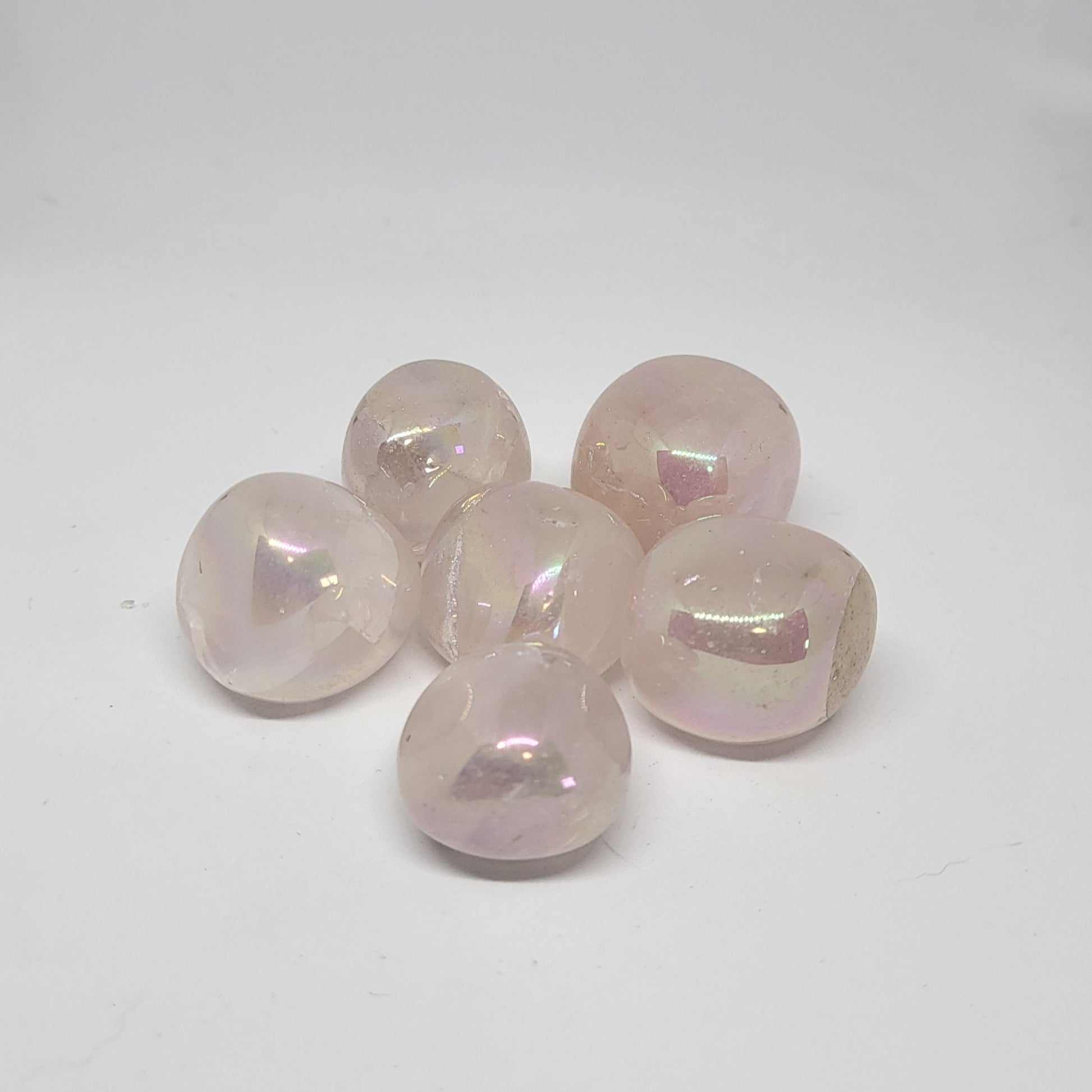 Set of six rose quartz beads on a white background