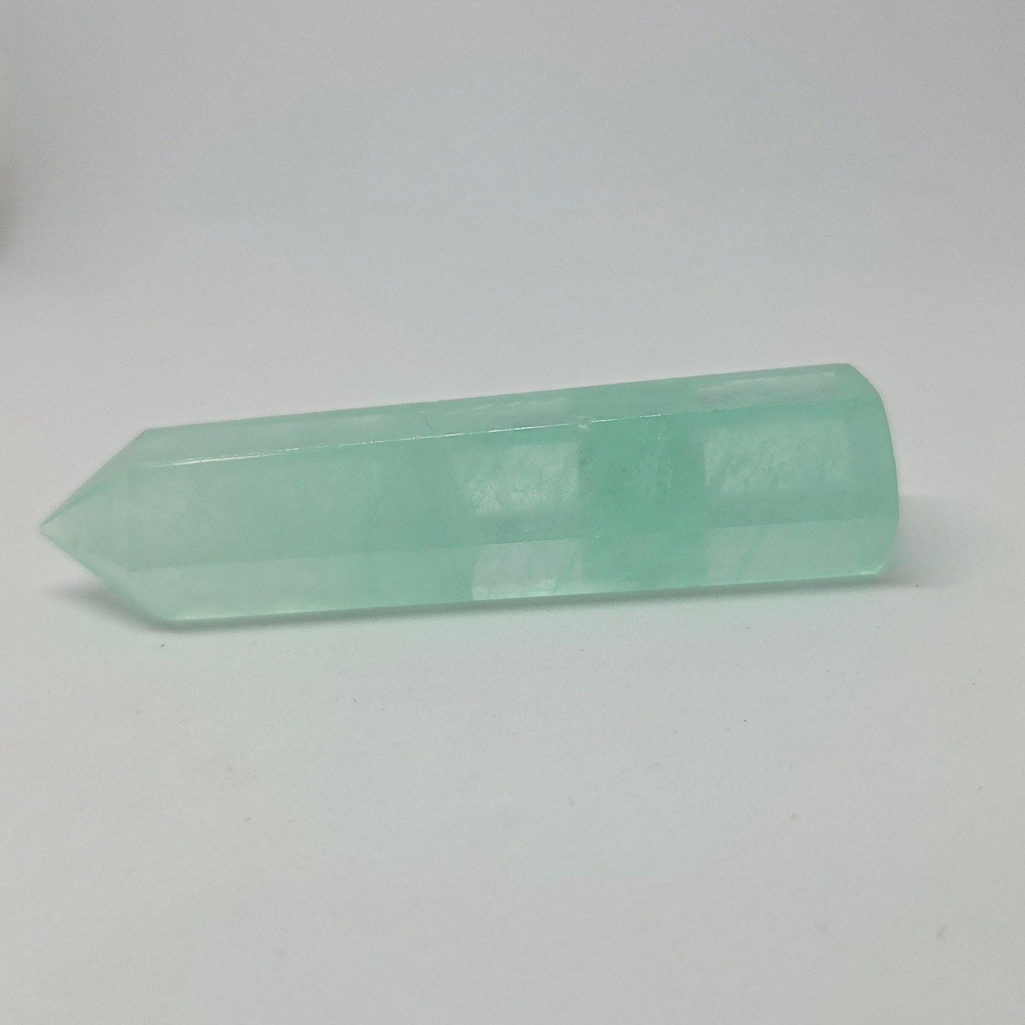Green Fluorite Energy Crystal laying down, pointing to the left.