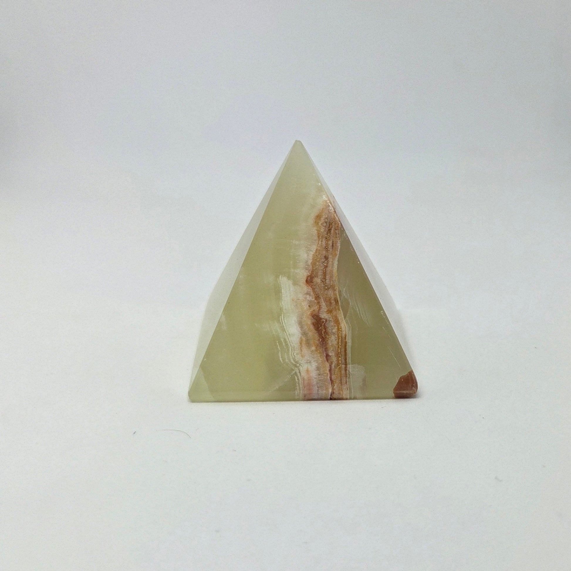 Triangular stone with brown and white patterns on a white background