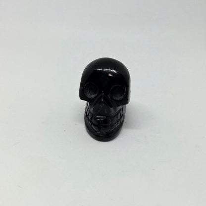 Black skull-shaped object on a white background