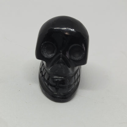 Black skull-shaped object on a white background