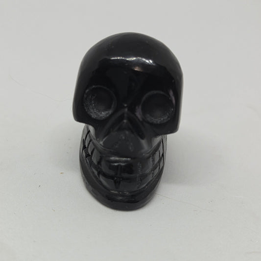 Black skull-shaped object on a white background