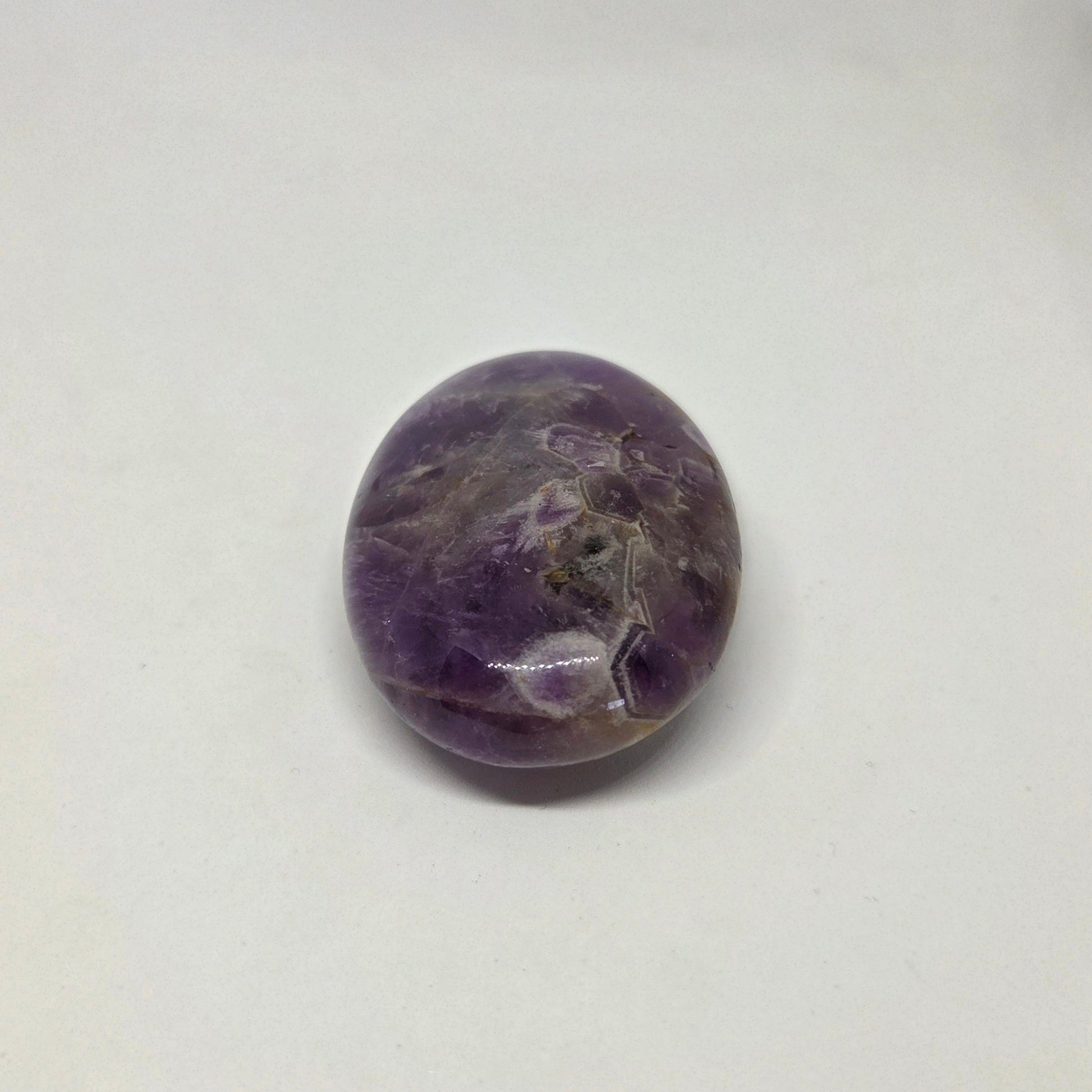 Round purple stone on a white background