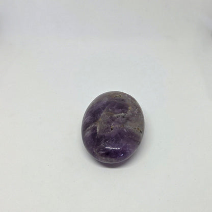 Purple amethyst stone on a white background