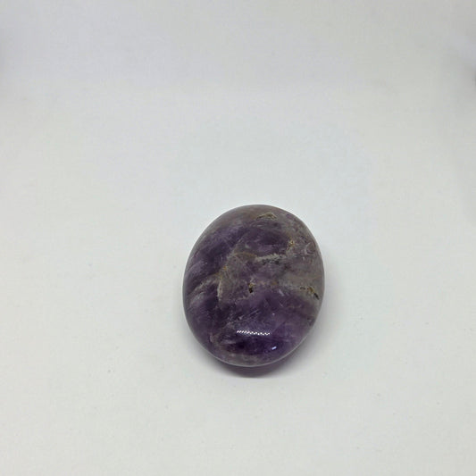 Purple amethyst stone on a white background