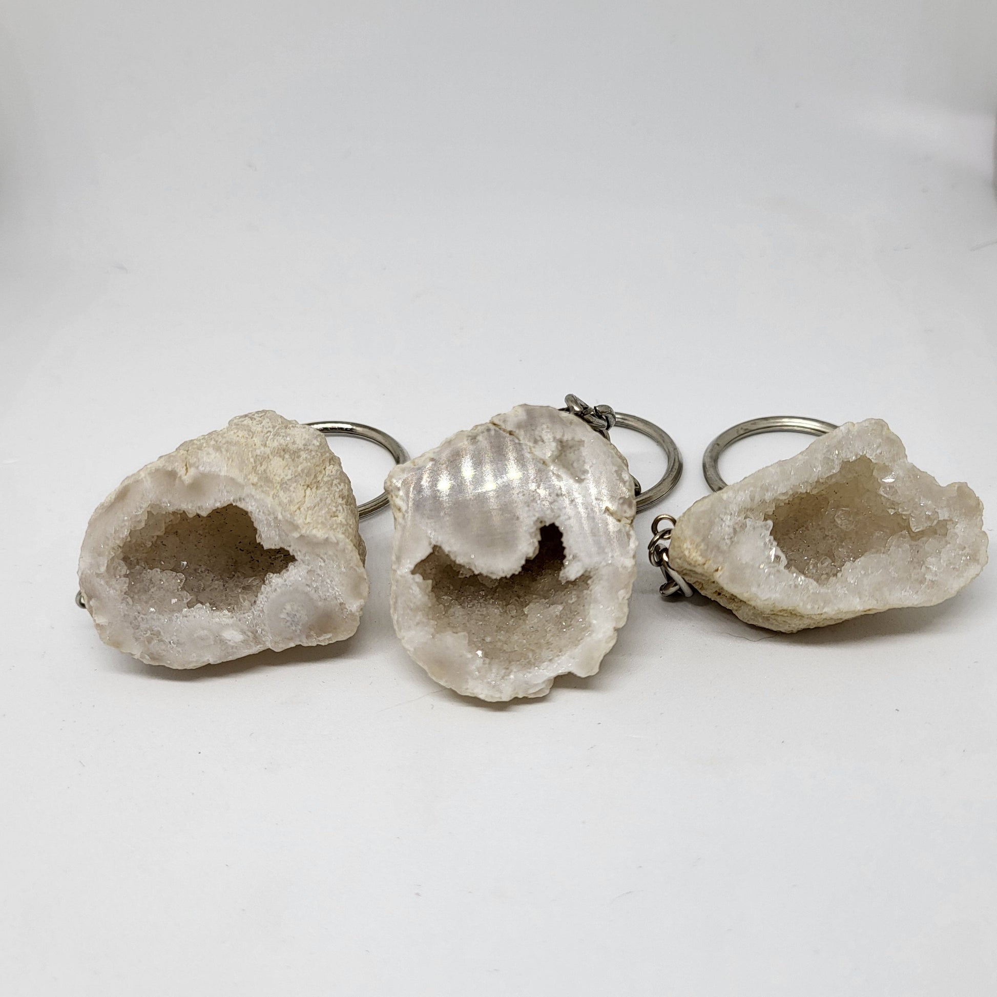 Three Quartz Geode keychains with silver metal clasps, displayed against a white background.