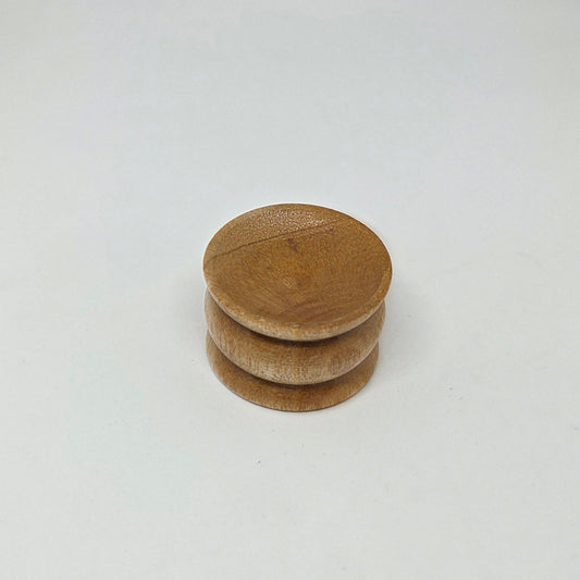 Stack of three wooden coasters on a white background