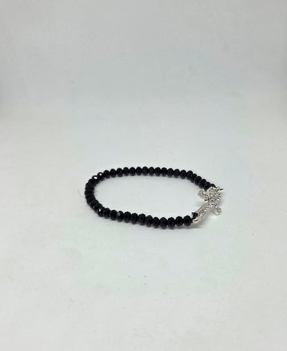 Black beaded bracelet with a silver clasp on a white background
