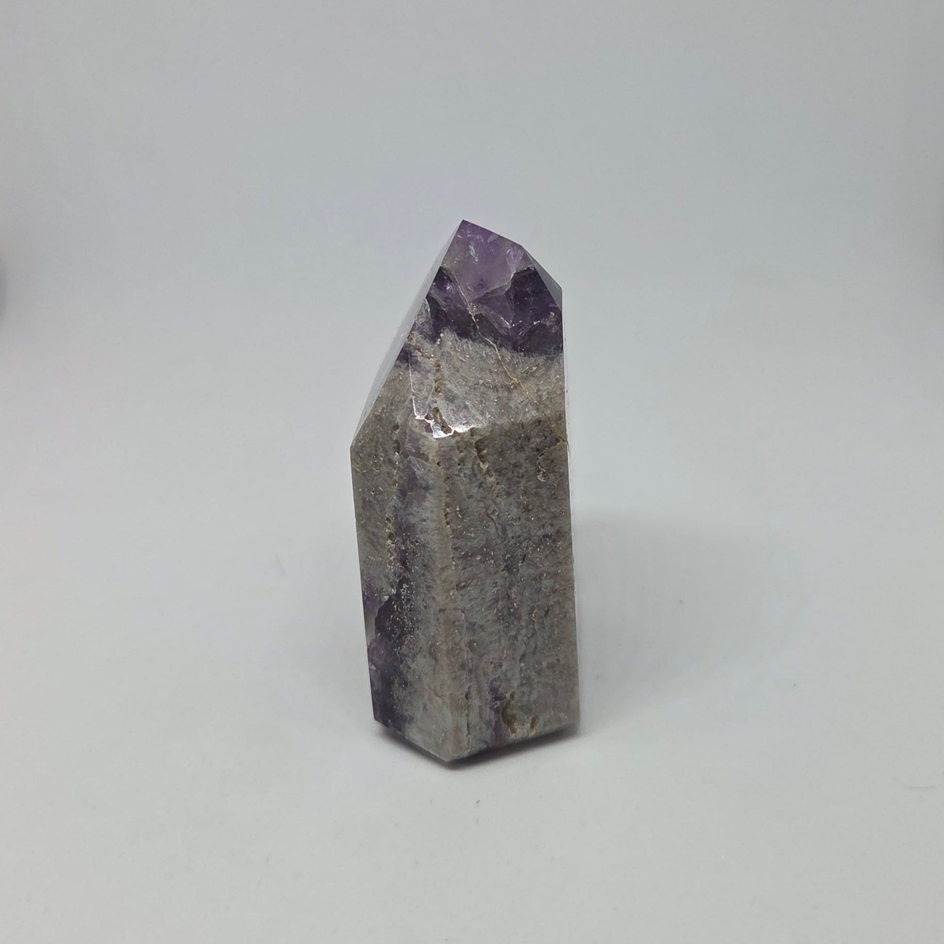 Geometric crystal with purple top on a white background