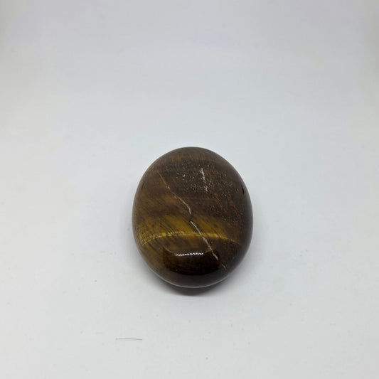 Oval-shaped brown stone on a white background