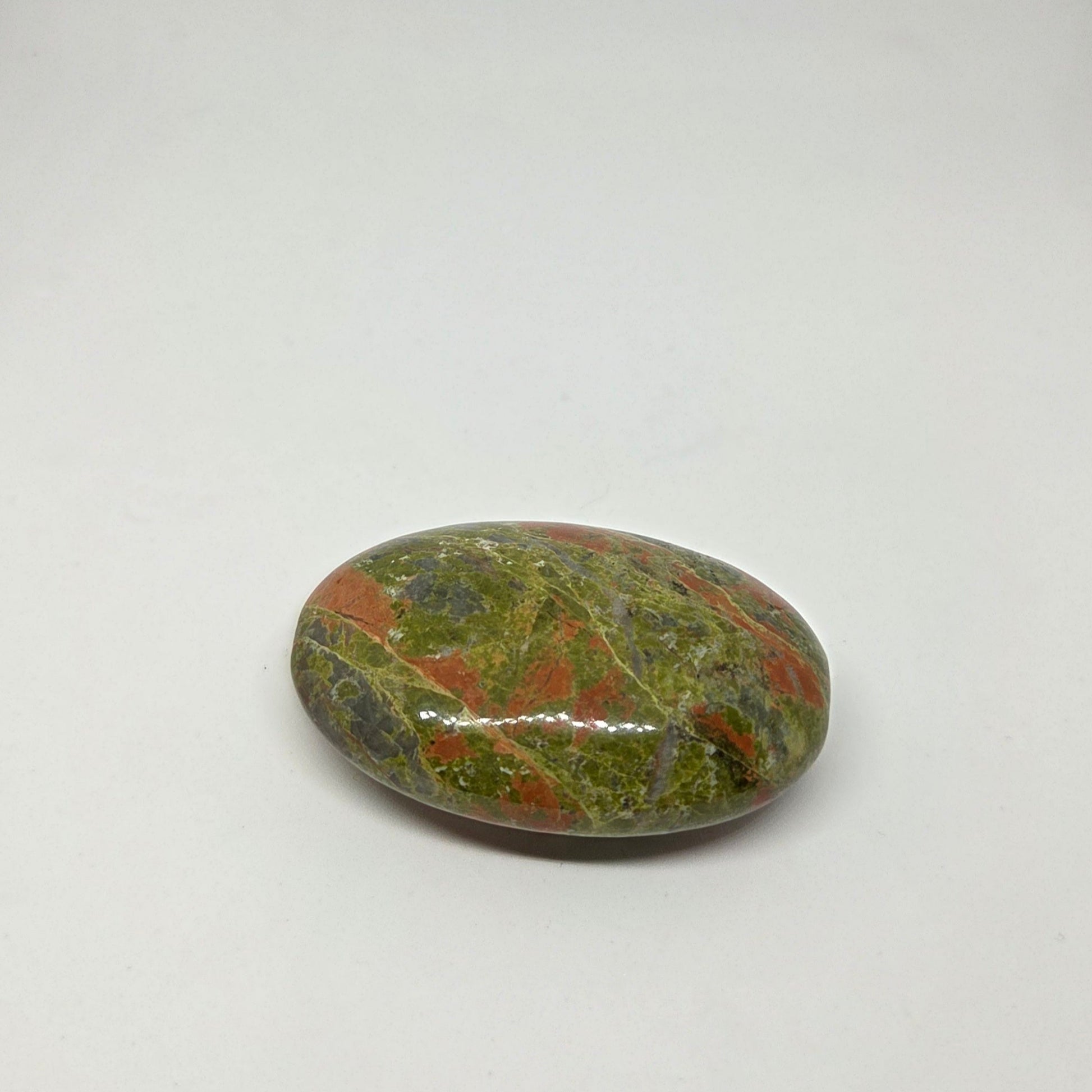 Polished multicolored stone on a white background