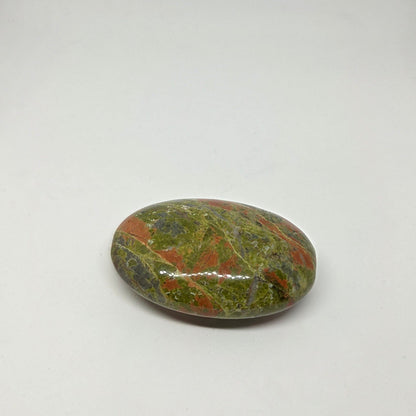 Polished multicolored stone on a white background