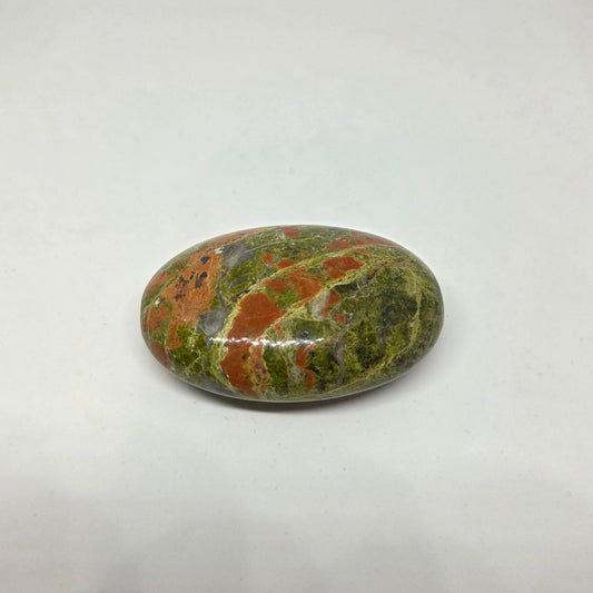 Polished multicolored stone on a white background