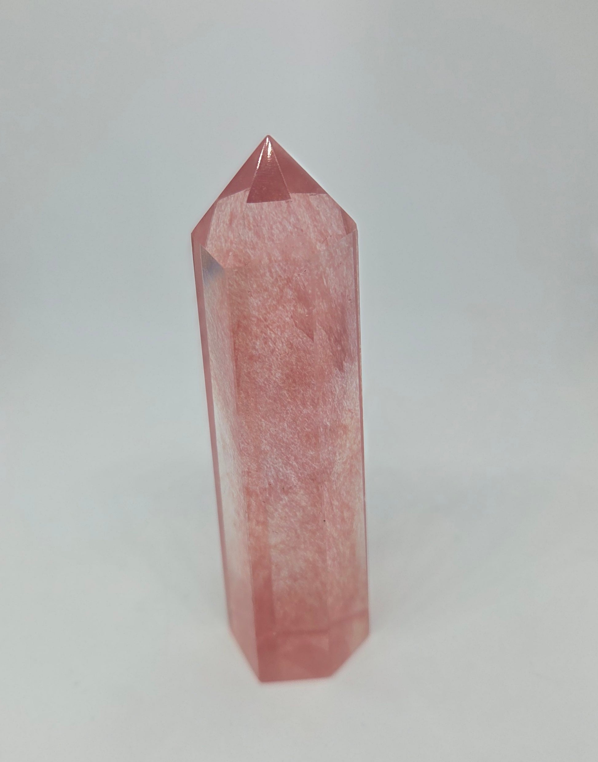 Pink glass crystal tower on a white background