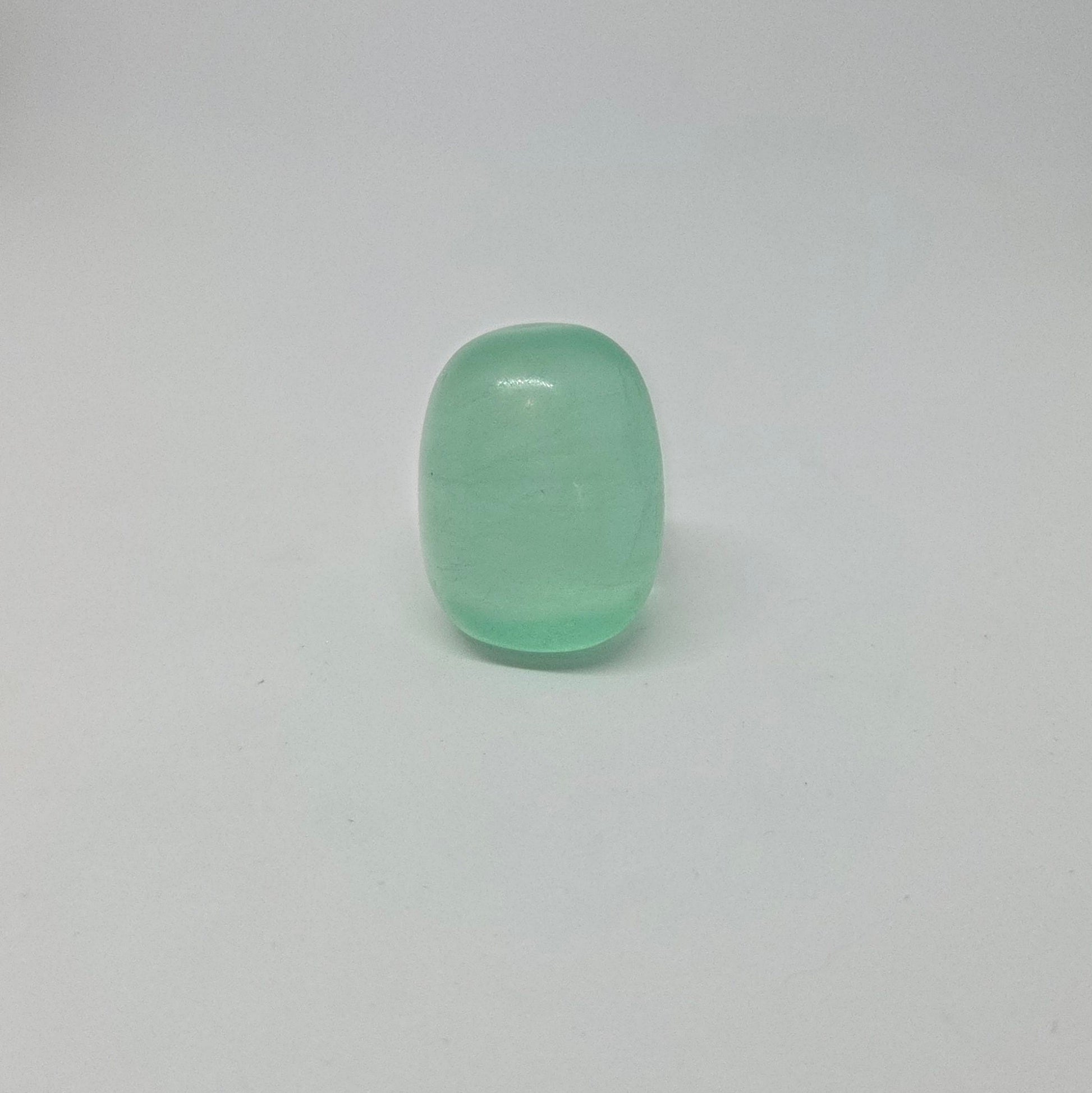 Green fluorite healing tumble, standing upright.