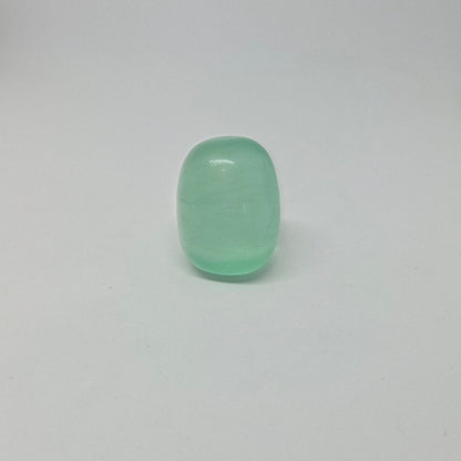 Green fluorite healing tumble, standing upright.