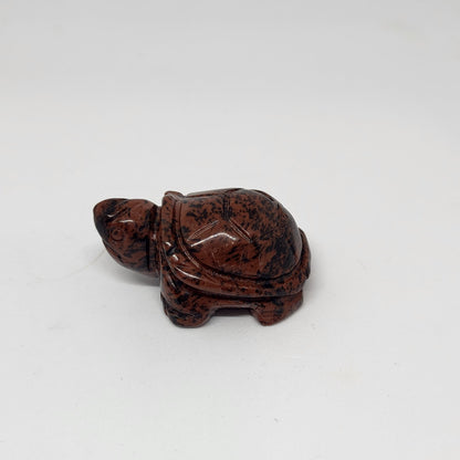 Brown stone turtle figurine on a white background