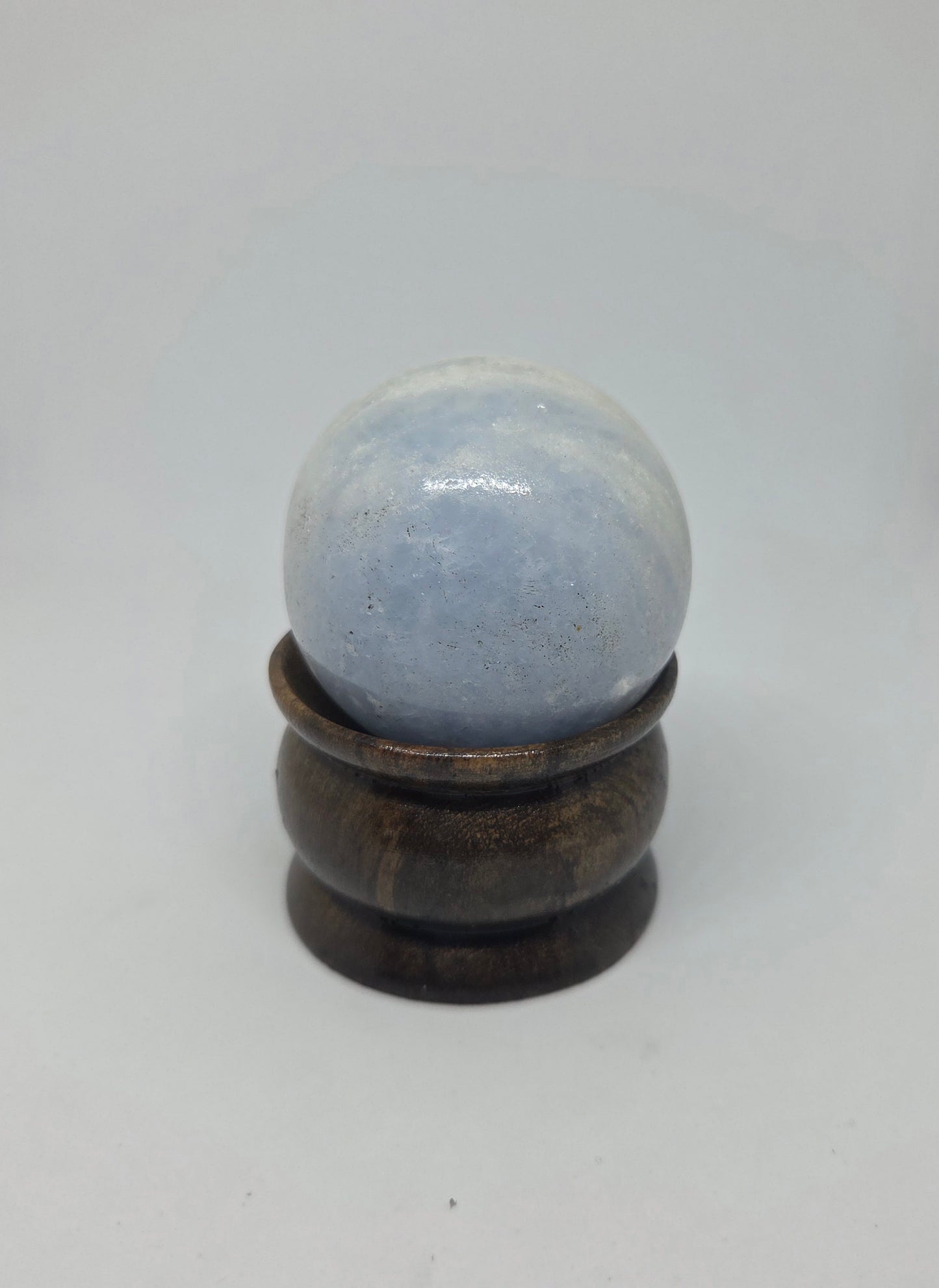 Blue Calcite Sphere Showing Natural Black Mineral Inclusions