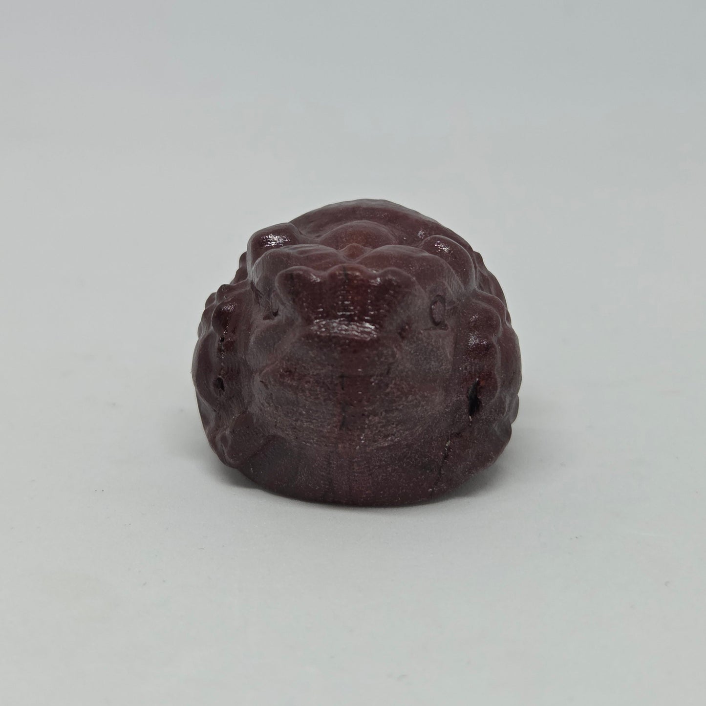 Brown stone with a textured surface on a light gray background