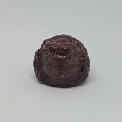 Brown stone with a textured surface on a light gray background